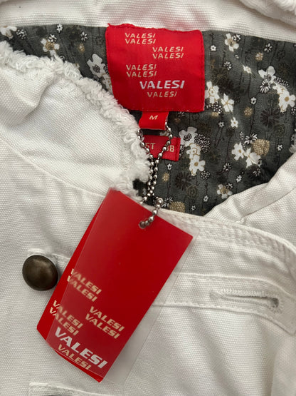 Close-up of a garment with 'VALESI' brand tags on a white background