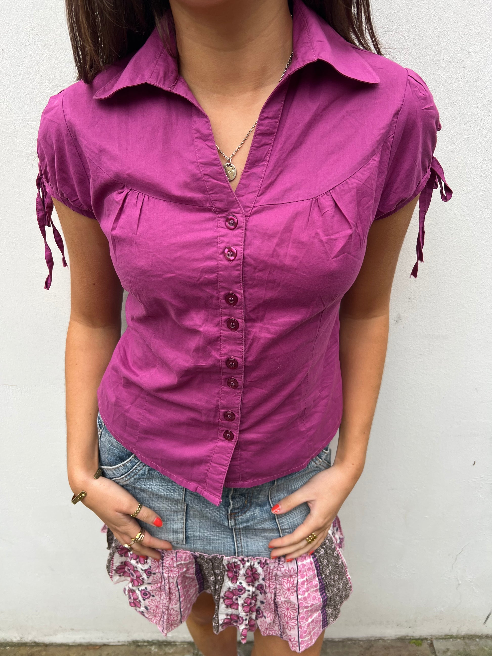 Person wearing a purple shirt with a white background